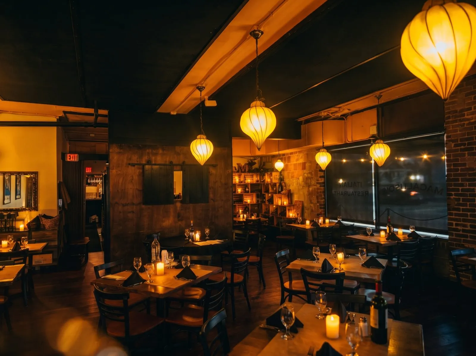Tables along the banquette, posters glowing above.