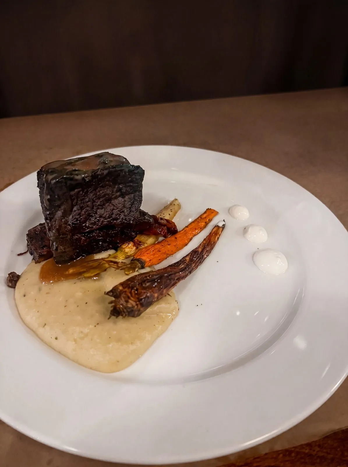 Braised short rib over puree with roasted carrots.